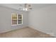 Cozy bedroom with carpet flooring, ceiling fan, and a window that offers plenty of natural light at 2711 Liberty Hall Ct, Waxhaw, NC 28173