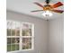 Bright bedroom with natural light coming through the window, wooden fan, and neutral walls at 2711 Liberty Hall Ct, Waxhaw, NC 28173