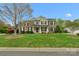 Charming two-story home featuring well-manicured lawn and mature trees at 2711 Liberty Hall Ct, Waxhaw, NC 28173