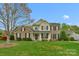 Charming home showcasing a manicured lawn, brick and vinyl exterior, complemented by blooming flowers at 2711 Liberty Hall Ct, Waxhaw, NC 28173