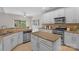 Well-lit kitchen featuring an island, stainless appliances, and ample counter space at 2711 Liberty Hall Ct, Waxhaw, NC 28173