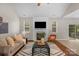Cozy living room with a fireplace, large screen TV and modern furnishings at 2711 Liberty Hall Ct, Waxhaw, NC 28173