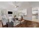 Open living room with hardwood floors, fireplace, and seamless flow to the kitchen and dining area at 2711 Liberty Hall Ct, Waxhaw, NC 28173