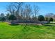 Stone monument at The Reserve entrance surrounded by landscaped green space and mature trees at 2711 Liberty Hall Ct, Waxhaw, NC 28173