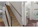 Inviting staircase leading to the upper level, complemented by the hardwood floors and natural light in the foyer at 2711 Liberty Hall Ct, Waxhaw, NC 28173