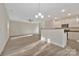 Bright and airy living room flows into a modern kitchen with an island and stainless steel appliances at 2729 Yurman Rd, Charlotte, NC 28214