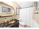 Bathroom with elegant fixtures, decorative mirror, and shower at 334 Hillcrest Dr, Mooresville, NC 28115