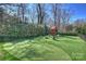 Large backyard features a putting green, playset and lounge seating at 4018 St Germaine Ln, Charlotte, NC 28210
