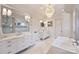 A luxurious primary bath featuring double vanities, a soaking tub, and a walk-in shower at 4018 St Germaine Ln, Charlotte, NC 28210