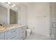 Bright bathroom features a marble vanity, shower with glass door and toilet at 4018 St Germaine Ln, Charlotte, NC 28210