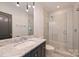Bathroom featuring patterned shower, marble counter and sleek fixtures at 4018 St Germaine Ln, Charlotte, NC 28210