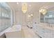 A modern bathroom with marble floors, a soaking tub, and double vanities at 4018 St Germaine Ln, Charlotte, NC 28210