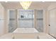 Gorgeous bathroom with an elegant soaking tub and separate glass-enclosed shower with refined finishes at 4018 St Germaine Ln, Charlotte, NC 28210
