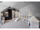 This sizable bonus room showcases shelving units, unique finishes and play space at 4018 St Germaine Ln, Charlotte, NC 28210