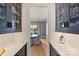 View from Butler's pantry into chic dining room with round table and views to the outside at 4018 St Germaine Ln, Charlotte, NC 28210