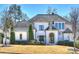 Stunning white brick home featuring a symmetrical design and a well-manicured front lawn at 4018 St Germaine Ln, Charlotte, NC 28210