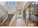 Elegant foyer featuring high ceilings, a wine cellar, and a staircase with designer carpet at 4018 St Germaine Ln, Charlotte, NC 28210