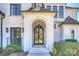 Arched front door with sidelights and stone steps creates a grand entrance to the home at 4018 St Germaine Ln, Charlotte, NC 28210