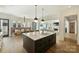 A modern kitchen with a large island and open-concept layout flowing into the dining and living areas at 4018 St Germaine Ln, Charlotte, NC 28210