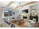 Bright living room features wood beams, stone fireplace, and a wall of sliding doors to the outside at 4018 St Germaine Ln, Charlotte, NC 28210