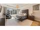 A luxurious main bedroom suite with a large window, tray ceiling and hardwood floors at 4018 St Germaine Ln, Charlotte, NC 28210