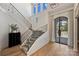 Elegant staircase with patterned carpet runner and high ceilings with large windows for natural light at 4018 St Germaine Ln, Charlotte, NC 28210