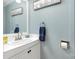 Clean bathroom with white vanity, blue walls, decorative mirror, and ample counter space for your needs at 422 Lee Ave, Wadesboro, NC 28170
