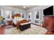 Serene bedroom with a king-size bed, patterned rug, and large windows providing ample natural light at 422 Lee Ave, Wadesboro, NC 28170