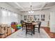 Bright dining room featuring hardwood floors, coffered ceilings, built-in cabinets, and a spacious seating arrangement at 422 Lee Ave, Wadesboro, NC 28170