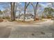 Spacious lot showcasing a home with mature trees and ample parking, creating a serene environment at 422 Lee Ave, Wadesboro, NC 28170