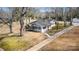 Exterior angle of home with large backyard, mature trees, and long driveway on a sunny day at 422 Lee Ave, Wadesboro, NC 28170