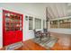 Inviting front porch featuring a vibrant red door, stylish seating, and a welcoming ambiance for relaxing outdoors at 422 Lee Ave, Wadesboro, NC 28170