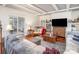 Bright living room features hardwood floors, coffered ceilings, a comfortable seating arrangement, and an entertainment center at 422 Lee Ave, Wadesboro, NC 28170