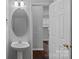 Clean half bathroom featuring a pedestal sink and neutral decor at 4264 Glenlea Commons E Dr, Charlotte, NC 28216