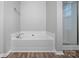 Soaking tub with tile surround and modern fixtures and shower at 4264 Glenlea Commons E Dr, Charlotte, NC 28216