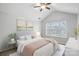 Bright bedroom with ceiling fan, large window, and tasteful decor at 4264 Glenlea Commons E Dr, Charlotte, NC 28216