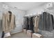 Walk-in closet featuring built-in shelving and ample storage at 4264 Glenlea Commons E Dr, Charlotte, NC 28216