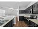 Modern kitchen with granite countertops, stainless steel appliances, and dark cabinets at 4264 Glenlea Commons E Dr, Charlotte, NC 28216