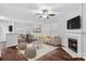 Bright living room featuring a fireplace, ceiling fan, and neutral decor at 4264 Glenlea Commons E Dr, Charlotte, NC 28216