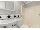 Cozy bathroom features a classic black and white tile backsplash, and a shower with tiled surround at 434 W 8Th St, Charlotte, NC 28202