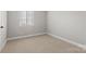 Cozy bedroom featuring neutral carpeting and a bright window with blinds at 434 W 8Th St, Charlotte, NC 28202