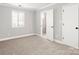 Neutral bedroom with carpet, a window, and a glimpse of a white-tiled bathroom through an open door at 434 W 8Th St, Charlotte, NC 28202