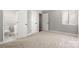 Neutral bedroom with carpet, a window, and a glimpse of a white-tiled bathroom through an open door at 434 W 8Th St, Charlotte, NC 28202