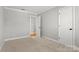 Bedroom featuring neutral carpet and white trim, adjacent to entry at 434 W 8Th St, Charlotte, NC 28202