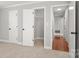 A closet with wire shelving is viewed from a carpeted bedroom with a glimpse of hardwood floors in hallway at 434 W 8Th St, Charlotte, NC 28202