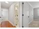 Hallway leads to a bathroom with black and white tile at 434 W 8Th St, Charlotte, NC 28202