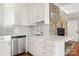 Kitchen features stainless steel dishwasher, white cabinetry, and a view of the stone fireplace at 434 W 8Th St, Charlotte, NC 28202