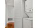 A clean and efficient laundry area featuring a stacked washer and dryer set and a view of wood floors at 434 W 8Th St, Charlotte, NC 28202