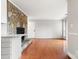Open living room with stone fireplace and hardwood floors adjacent to kitchen at 434 W 8Th St, Charlotte, NC 28202