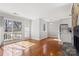 Open concept living room with hardwood floors, stone fireplace and sliding doors to a balcony at 434 W 8Th St, Charlotte, NC 28202